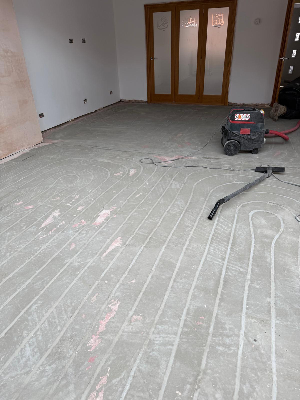 Retrofit floor milling cutting heating channels into concrete in a Cheshire home