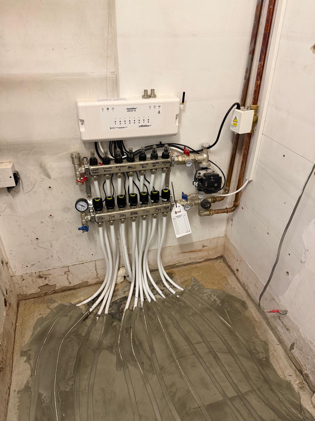 Heatmiser underfloor heating manifold installed and labelled by BHL